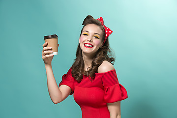 Image showing Beautiful young woman with pinup make-up and hairstyle. Studio shot on white background