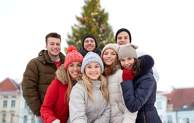 Image showing happy friends over christmas tree in old tallinn