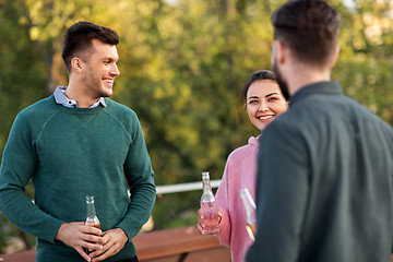 Image showing happy friends with drinks at rooftop party