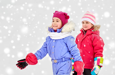 Image showing happy little girls in winter clothes outdoors