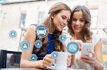 Image showing women using car sharing app on smartphone at cafe