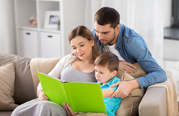 Image showing happy family reading book at home