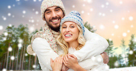 Image showing couple hugging over winter forest and snow