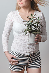 Image showing Young woman holding a beautiful Panda plant