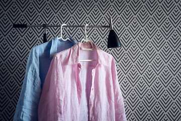 Image showing Pink and blue shirts on wallpaper background