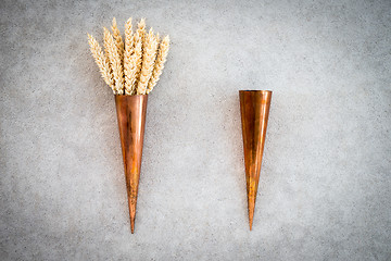 Image showing Two vintage copper cones with wheat ears