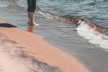 Image showing Man standing in water by the seaside