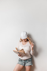 Image showing Casual young woman reading a book