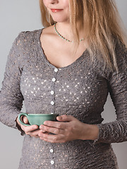 Image showing Young woman with turquoise teacup