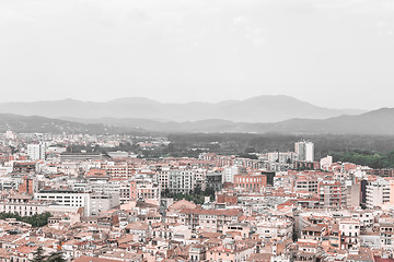 Image showing Rooftops and mountains