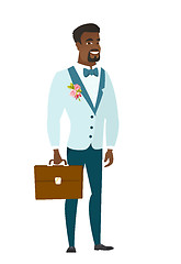 Image showing African-american groom holding briefcase.