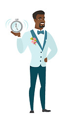 Image showing African-american groom holding alarm clock.