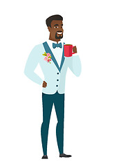 Image showing Young african-american groom holding cup of coffee