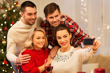 Image showing friends taking selfie at christmas dinner