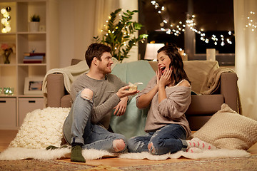 Image showing happy couple with gift box at home