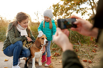 Image showing family photographing by smartphone on autumn beach