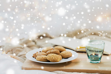 Image showing oatmeal cookies and candle in holder at home