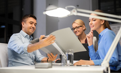 Image showing business team with papers working late at office