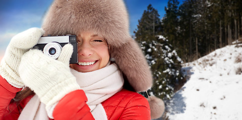 Image showing happy woman with film camera over winter forest