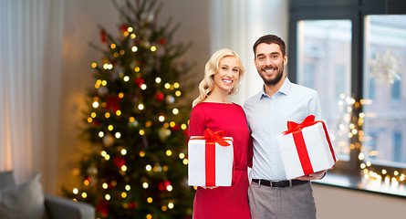 Image showing happy couple with christmas gifts at home