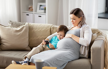 Image showing pregnant mother and son with smartphone at home