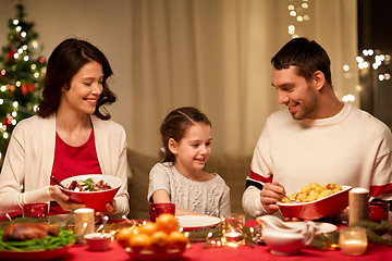 Image showing happy family having christmas dinner at home