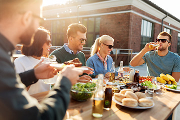 Image showing friends having dinner or bbq party on rooftop