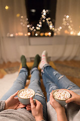 Image showing close up of couple drinking hot chocolate at home