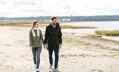 Image showing couple walking along autumn beach