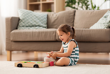 Image showing happy baby girl playing with toy blocks at home