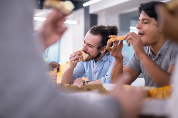 Image showing multiethnic business team eating pizza