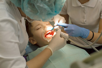 Image showing Orthodontist examining boy mouth