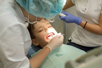 Image showing Orthodontist examining boy mouth