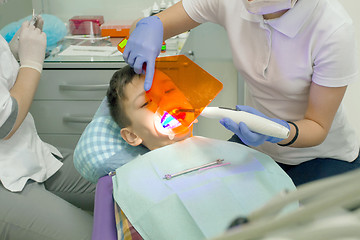 Image showing Orthodontist examining boy mouth