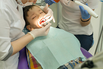 Image showing Orthodontist examining boy mouth