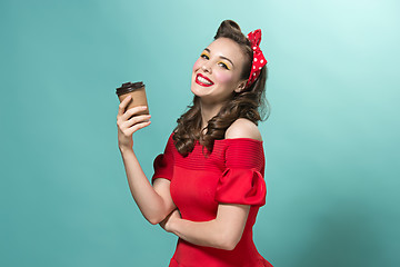 Image showing Beautiful young woman with pinup make-up and hairstyle. Studio shot on white background