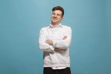 Image showing The happy business man standing and smiling against studio background.