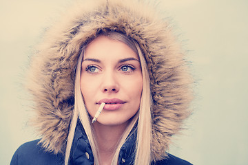 Image showing portrait of young blonde girl with cigarette in the mouth