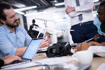 Image showing multiethnic business team learning about drone technology