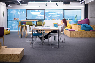 Image showing redhead businesswoman using mobile phone at office