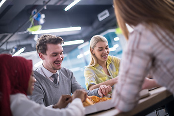 Image showing multiethnic business team eating pizza