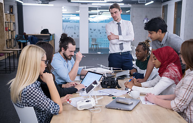 Image showing multiethnic business team learning about drone technology