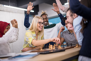 Image showing multiethnic group of business people playing chess