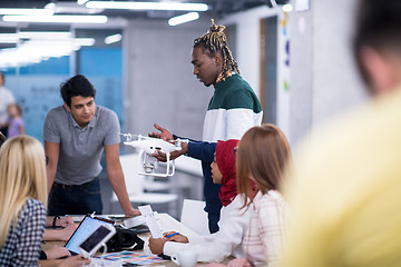 Image showing multiethnic business team learning about drone technology