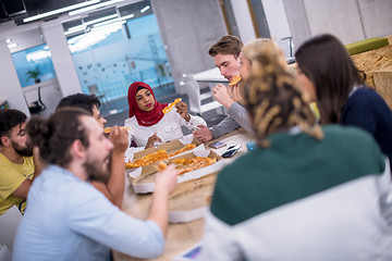 Image showing multiethnic business team eating pizza