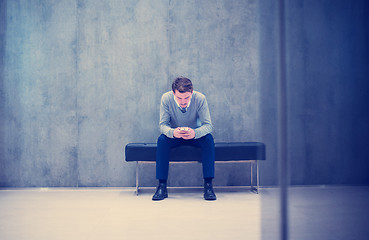 Image showing businessman using smart phone while sitting on the bench