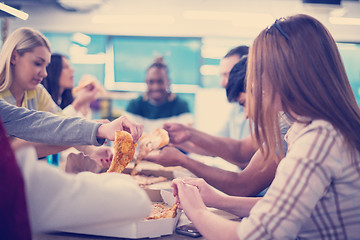 Image showing multiethnic business team eating pizza