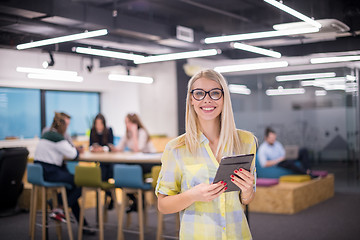 Image showing blonde businesswoman working online using digital tablet