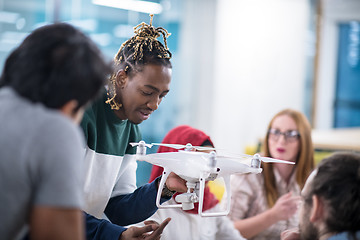 Image showing multiethnic business team learning about drone technology