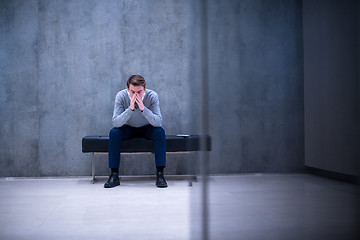 Image showing businessman using smart phone while sitting on the bench